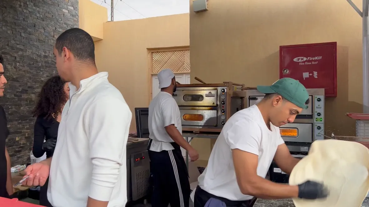 Pizza being prepared by hand